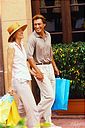 CB061690 - Couple Holding Shopping Bags
